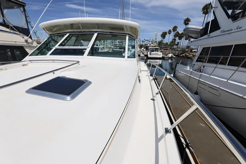Slide: The Image of 2003 Tiara 4000 EXPRESS yacht docked at marina with clear blue sky. - 6