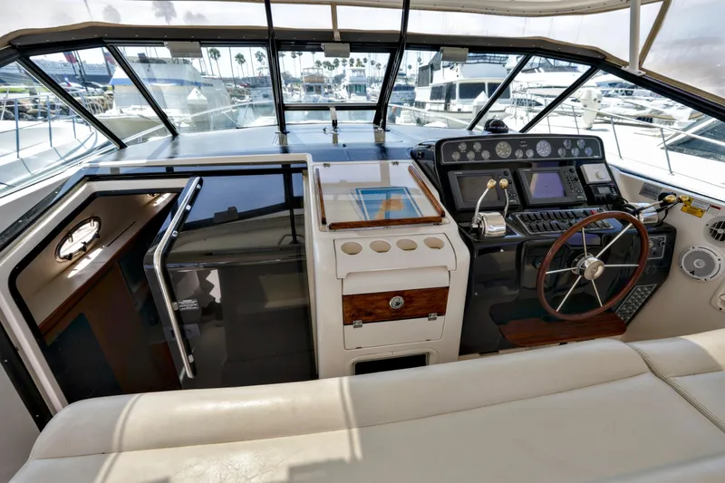 Slide: The Image of Cockpit of 2003 Tiara 4000 EXPRESS yacht with steering wheel and navigation controls. - 9