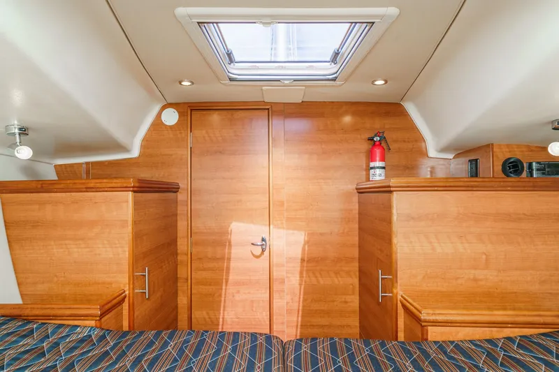 Slide: The Image of Interior cabin of 2015 Hunter 33 yacht with wood finish and fire extinguisher. - 23