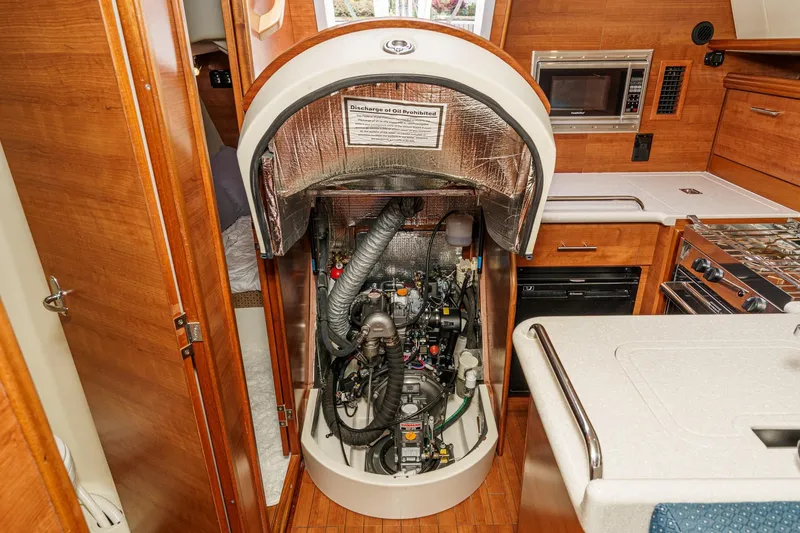 Slide: The Image of Engine compartment of a 2015 Hunter 33 sailboat, showcasing interior design and equipment. - 25