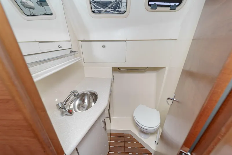 Slide: The Image of Compact bathroom in 2015 Hunter 33 yacht with sink, toilet, and storage. - 31