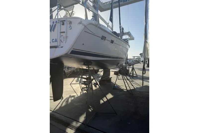 Slide: The Image of 2015 Hunter 33 sailboat on dry dock, undergoing maintenance at a marina. - 32