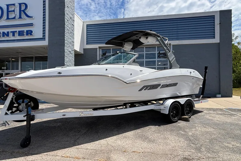 Slide: The Image of 2026 MB B52 23 Alpha boat on trailer outside dealership, sunny day. - 10