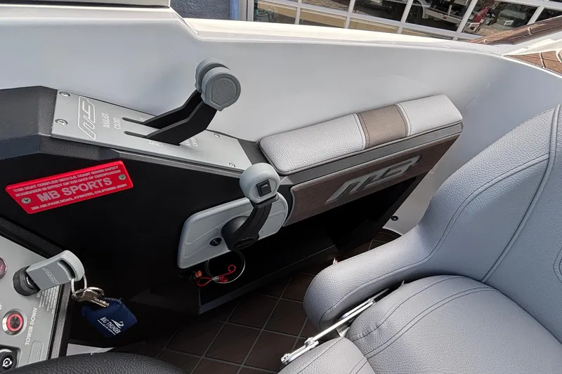 Slide: The Image of Interior of 2026 MB B52 23 Alpha boat, featuring control panel and seating. - 14