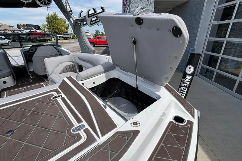 Slide: The Image of 2026 MB B52 23 Alpha boat interior with open storage compartment and seating. - 22