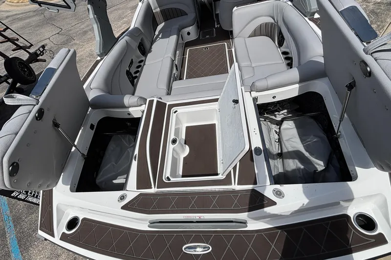 Slide: The Image of 2026 MB B52 23 Alpha boat interior with open storage compartments and seating. - 23