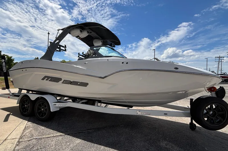 Slide: The Image of 2026 MB B52 23 Alpha boat on trailer under blue sky. - 29