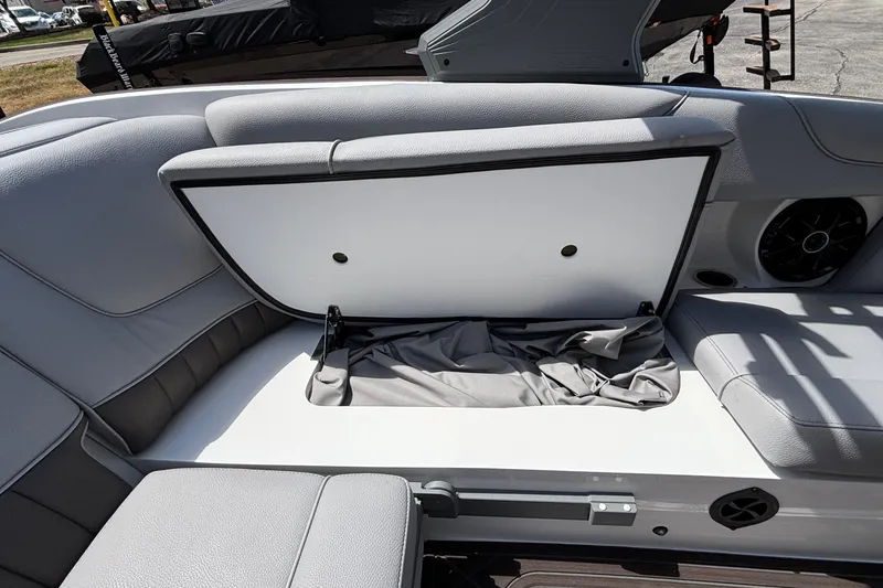 Slide: The Image of 2026 MB B52 23 Alpha boat interior with open storage compartment and gray seating. - 32