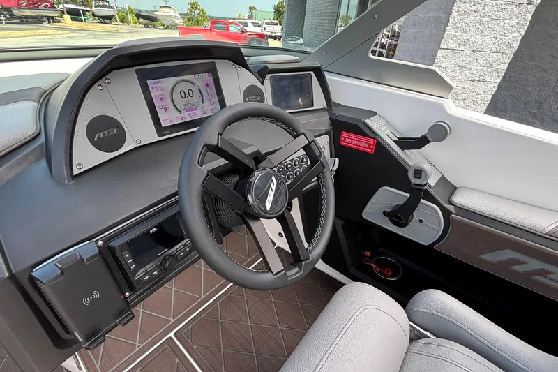 Slide: The Image of 2026 MB B52 23 Alpha boat dashboard with advanced controls and digital display. - 34