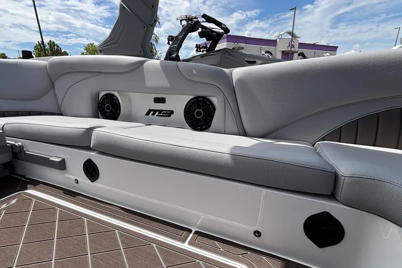 Slide: The Image of Interior of 2026 MB B52 23 Alpha boat with gray seating and speakers. - 7