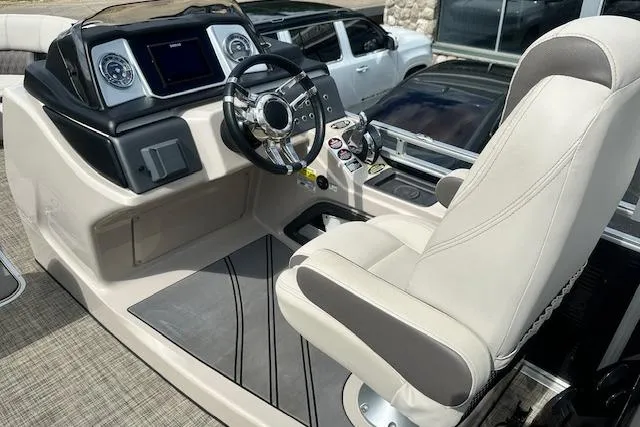 Slide: The Image of 2020 Harris Solstice 250 boat cockpit with steering wheel and control panel. - 16