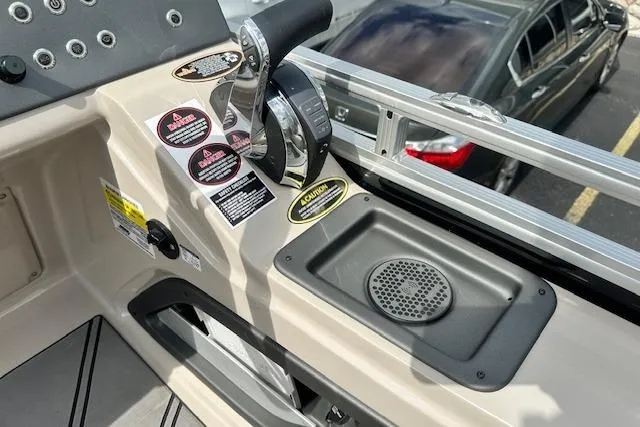 Slide: The Image of 2020 Harris Solstice 250 boat console with controls and warning labels. - 17