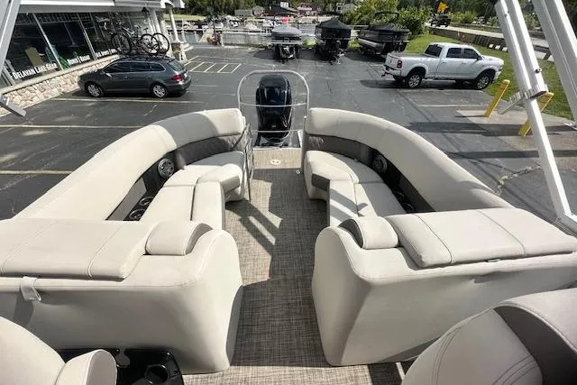 Slide: The Image of 2020 Harris Solstice 250 pontoon boat with spacious seating, parked in a lot. - 36