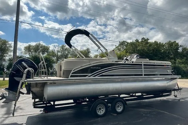 Slide: The Image of 2020 Harris Solstice 250 pontoon boat on trailer, parked outdoors under cloudy sky. - 4
