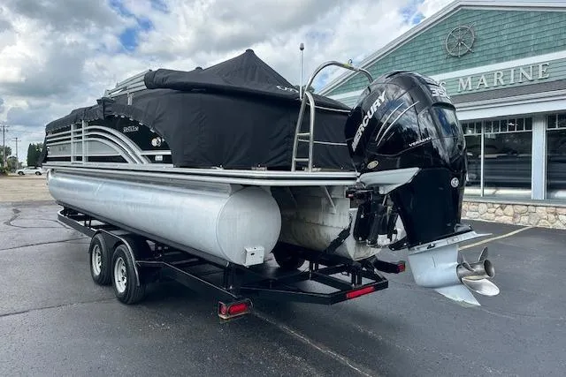 Slide: The Image of 2020 Harris Solstice 250 pontoon boat on trailer, covered, with Mercury outboard motor. - 40