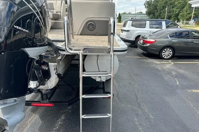 Slide: The Image of 2020 Harris Solstice 250 boat with ladder and Verado engine in parking lot. - 6