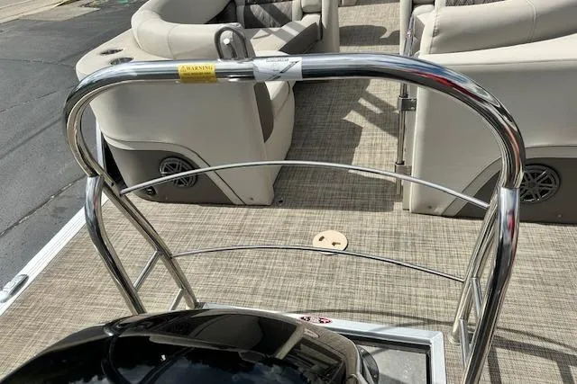 Slide: The Image of 2020 Harris Solstice 250 boat interior with beige seating and chrome railing. - 8