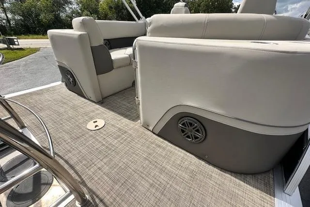 Slide: The Image of 2020 Harris Solstice 250 boat interior with beige seating and carpeted flooring. - 9