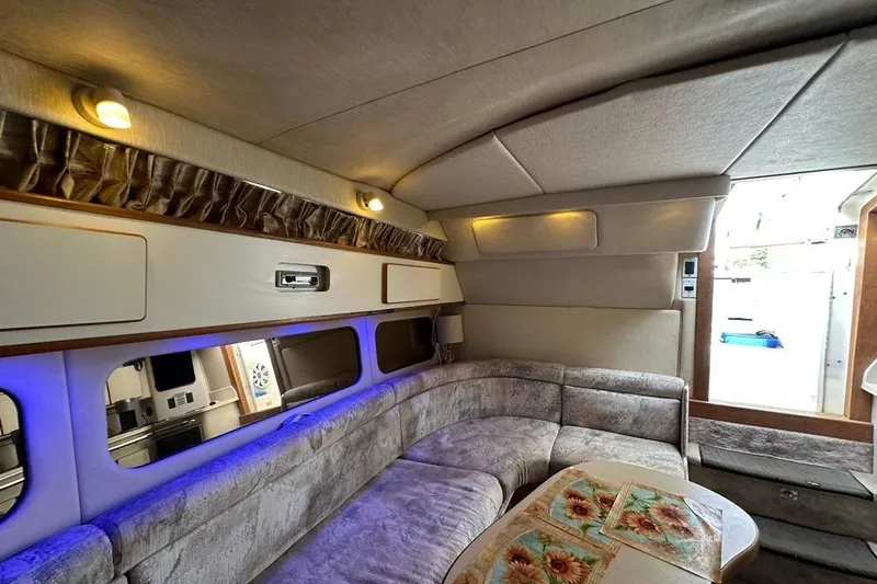 Slide: The Image of Luxurious interior of a 1994 Sea Ray 370 Express Cruiser with cozy seating and ambient lighting. - 21