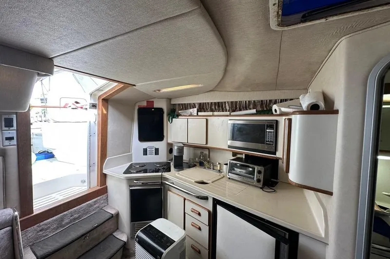 Slide: The Image of Interior of 1994 Sea Ray 370 Express Cruiser with kitchen appliances and cabinetry. - 22