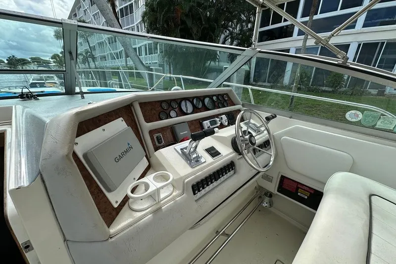 Slide: The Image of 1994 Sea Ray 370 Express Cruiser helm with Garmin navigation system and steering wheel. - 25