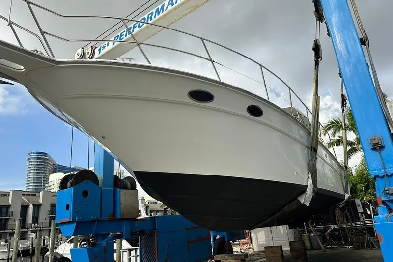 Slide: The Image of 1994 Sea Ray 370 Express Cruiser on a lift, marina background. - 3