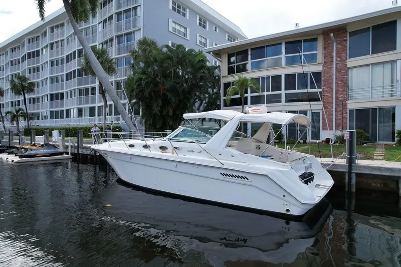 Slide: The Image of 1994 Sea Ray 370 Express Cruiser docked near waterfront apartments. - 38
