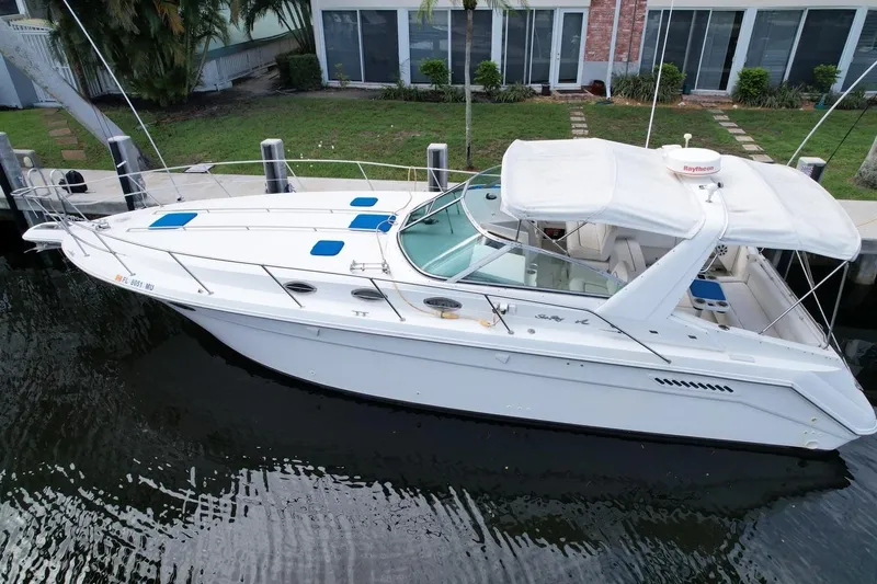 Slide: The Image of 1994 Sea Ray 370 Express Cruiser docked by waterfront home. - 41