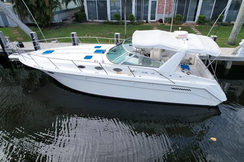 Slide: The Image of 1994 Sea Ray 370 Express Cruiser docked on calm water, side view. - 42