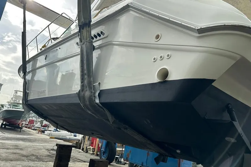 Slide: The Image of 1994 Sea Ray 370 Express Cruiser in dry dock, hull view. - 9