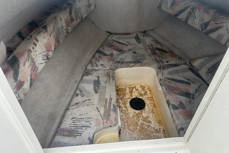 Slide: The Image of 2001 Sea Fox 204 Millenium boat interior with patterned cushions and storage compartment. - 10
