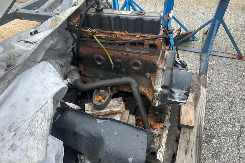 Slide: The Image of Rusty engine block on wooden pallet, likely from a 2001 Sea Fox 204 Millenium boat. - 15