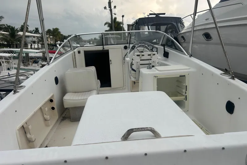 Slide: The Image of 2001 Sea Fox 204 Millenium boat interior with seating and steering wheel, docked at marina. - 4