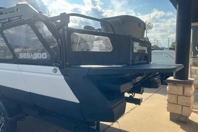 Slide: The Image of 2023 Sea Doo Switch pontoon boat, rear view, parked on a sunny day. - 13