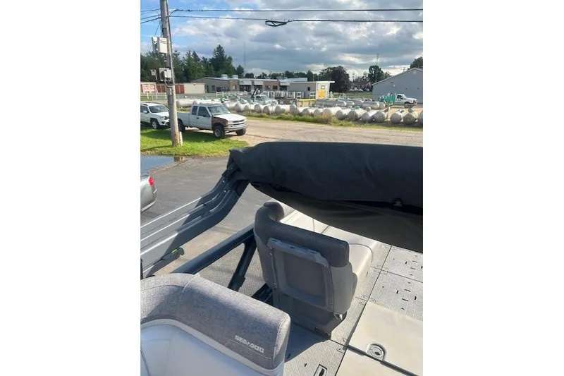 Slide: The Image of 2023 Sea Doo Switch boat interior with gray seating, outdoor setting in background. - 4