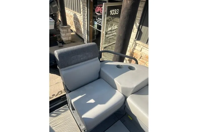 Slide: The Image of 2023 Sea Doo Switch boat seat with cup holders, outdoor setting. - 5