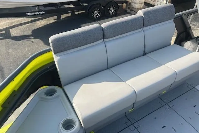 Slide: The Image of 2023 Sea Doo Switch boat interior with gray cushioned seating and cup holders. - 9