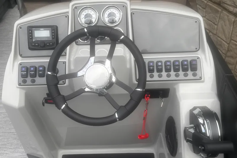 Slide: The Image of 2026 Starcraft EXS 3 Q DH boat dashboard with steering wheel and control panel. - 11