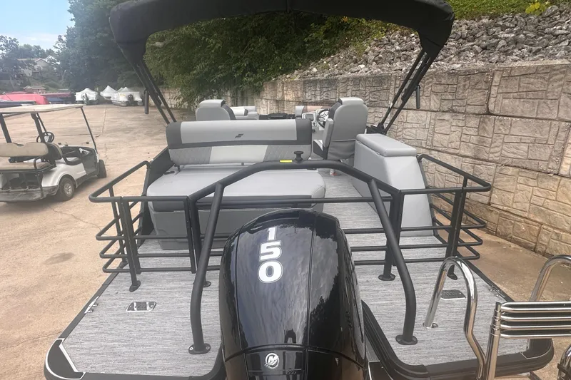 Slide: The Image of 2026 Starcraft EXS 3 Q DH pontoon boat with 150 HP engine, docked outdoors. - 13