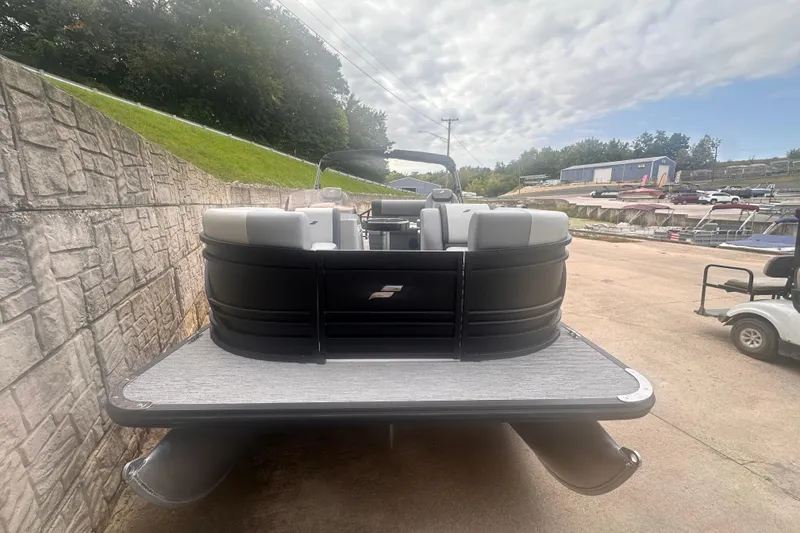 Slide: The Image of 2026 Starcraft EXS 3 Q DH pontoon boat, rear view, parked on concrete. - 2