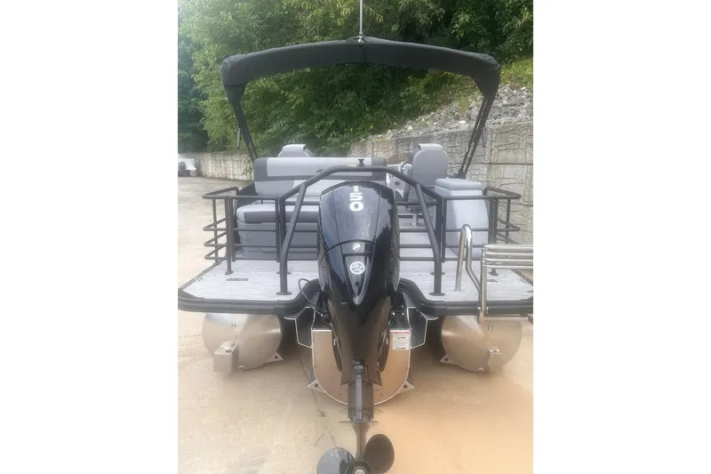 Slide: The Image of 2026 Starcraft EXS 3 Q DH pontoon boat with outboard motor, docked outdoors. - 4
