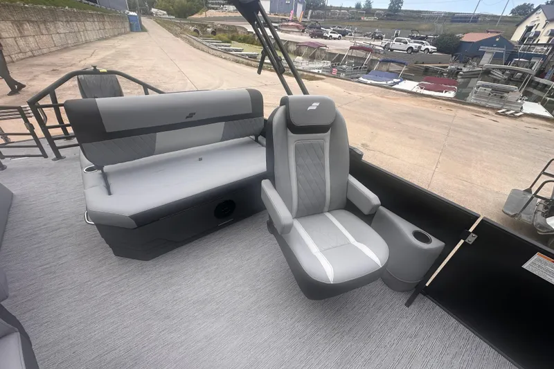 Slide: The Image of 2026 Starcraft EXS 3 Q DH boat interior with gray seating and cup holder. - 8