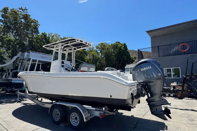 Slide: The Image of 2023 NauticStar 242L Offshore boat on trailer with Yamaha outboard motor. - 16
