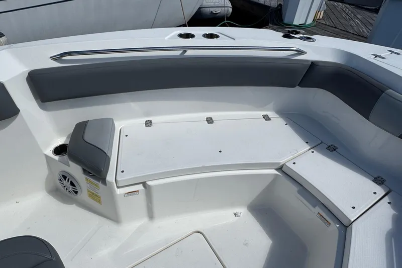 Slide: The Image of 2023 NauticStar 242L Offshore boat interior with cushioned seating and storage compartments. - 20