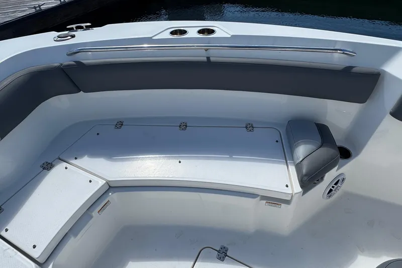 Slide: The Image of 2023 NauticStar 242L Offshore boat interior seating with storage compartments. - 22