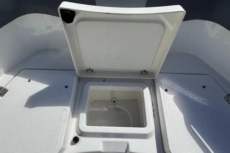 Slide: The Image of Open storage compartment on 2023 NauticStar 242L Offshore boat deck. - 26