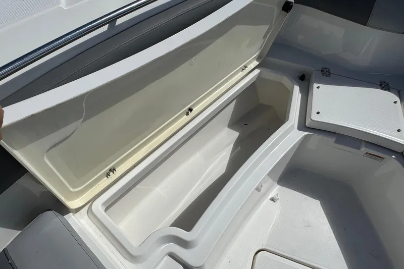 Slide: The Image of 2023 NauticStar 242L Offshore boat storage compartment, open and spacious design. - 27