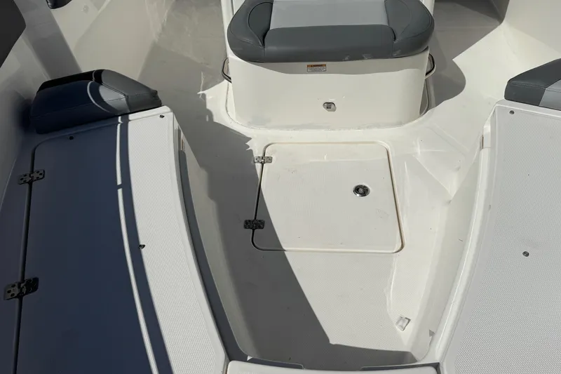 Slide: The Image of 2023 NauticStar 242L Offshore boat interior with seating and storage compartments. - 29