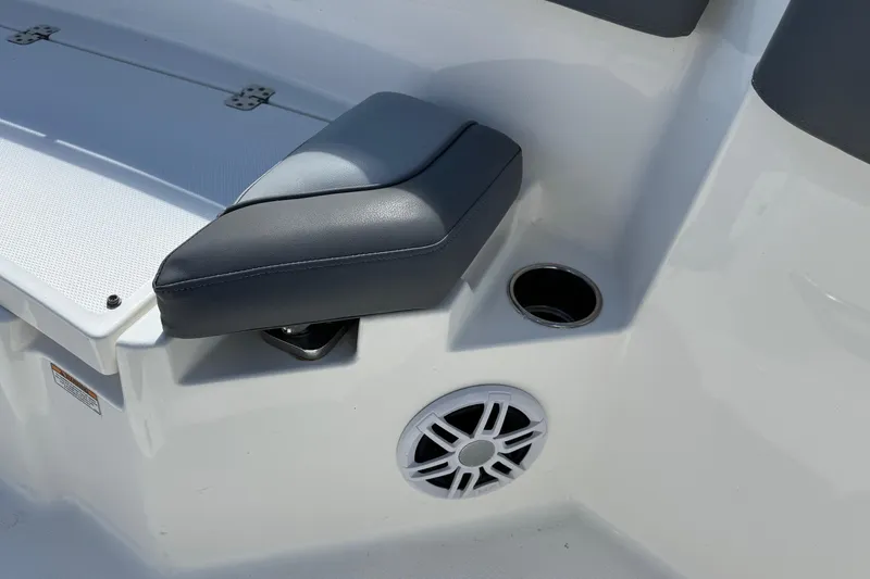Slide: The Image of 2023 NauticStar 242L Offshore boat interior with cushioned seat and speaker. - 31