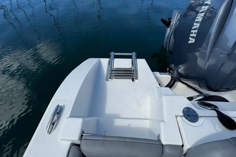 Slide: The Image of 2023 NauticStar 242L Offshore boat with Yamaha engine, featuring swim platform and ladder. - 43